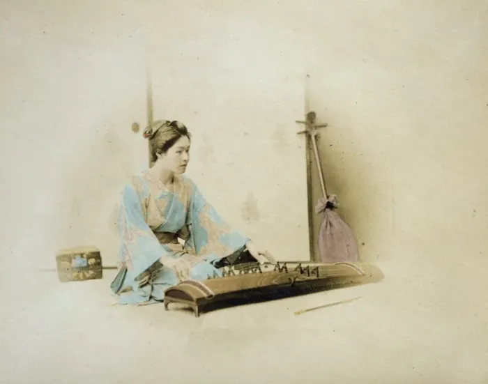 Framed Print : Japanese woman, full length, seated, facing right, playing a Framed Print : Japanese woman, full length, seated, facing right, playing a