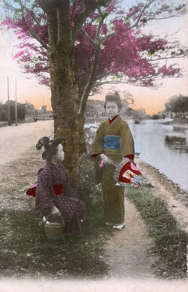 Two Japanese women by the side of a canal  /  river - Japan