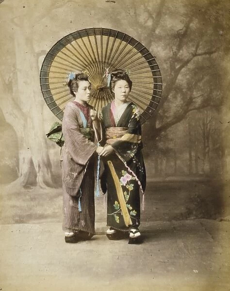 Two Japanese women, full-length studio portrait with backdro