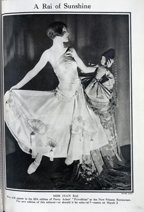 Framed Print : Jean Rai, cabaret performer, theatrical portrait in satin gown, with doll. Captioned, A Rai of Sunshine'. With description, Miss Jean Rai Framed Print : Jean Rai, cabaret performer, theatrical portrait in satin gown, with doll. Captioned, A Rai of Sunshine'. With description, Miss Jean Rai