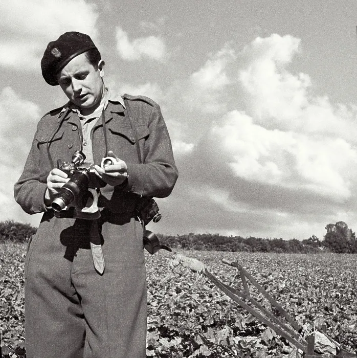 Framed Print : John standing in field in uniform carefully adjusting his camera. Yorkshire, Pickering area. One of a set of several-probably summer. Date: 1947 - 1948 Framed Print : John standing in field in uniform carefully adjusting his camera. Yorkshire, Pickering area. One of a set of several-probably summer. Date: 1947 - 1948