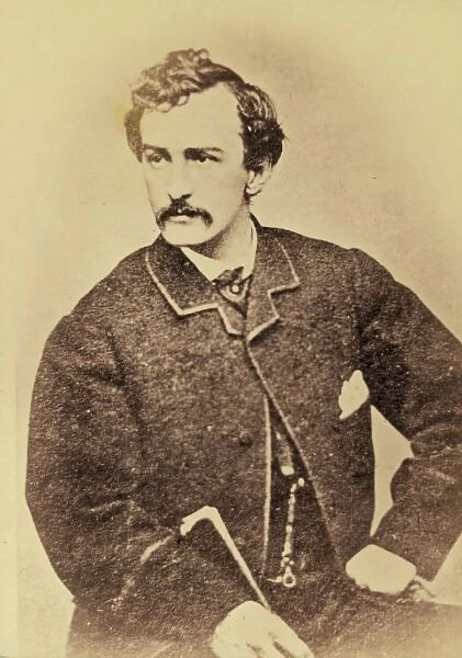 John Wilkes Booth, half-length portrait, facing left and hol