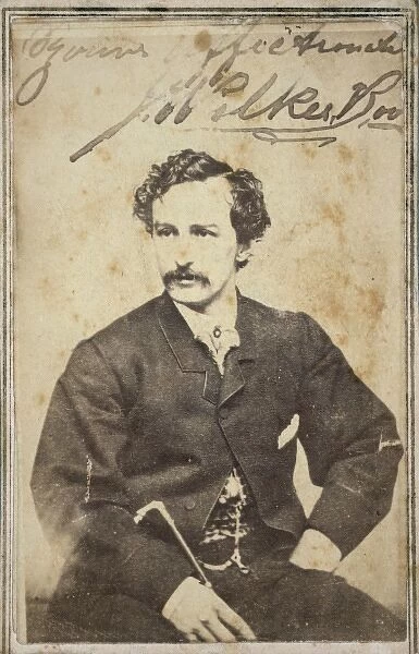 John Wilkes Booth, half-length studio portrait, sitting