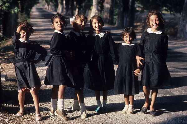 Six jolly little schoolgirls pose for the camera, Antalya