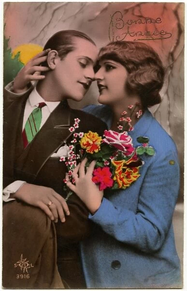 Kitsch New Years Greetings postcard featuring a young couple