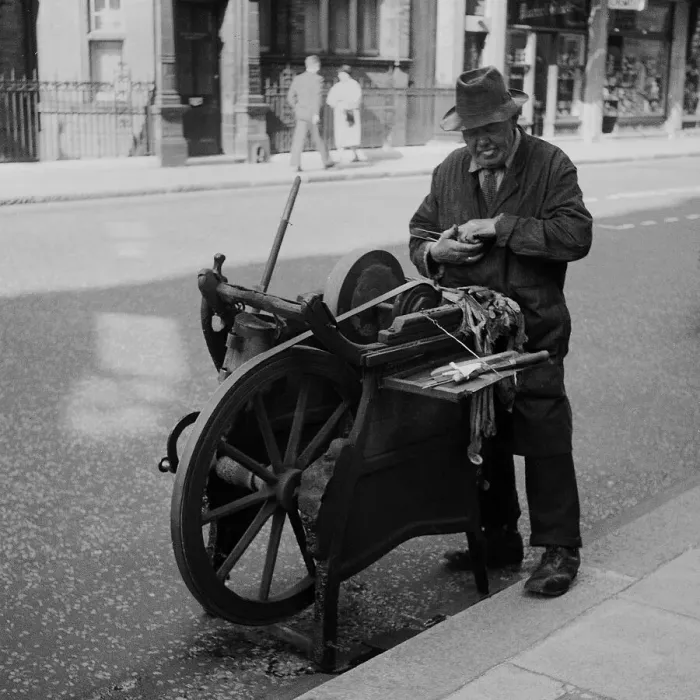 Framed Print : Knife grinder at work, Central London Framed Print : Knife grinder at work, Central London