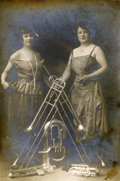 Framed Print : Two Lady Brass Musicians and a variety of their instruments Framed Print : Two Lady Brass Musicians and a variety of their instruments