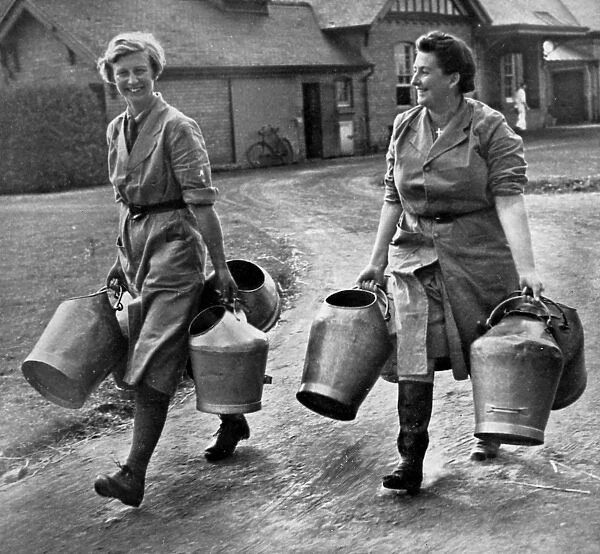 Land Army Girls carry milk pails, 1939