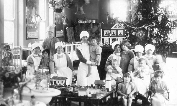 Large informal group of nurses and children, Christmas