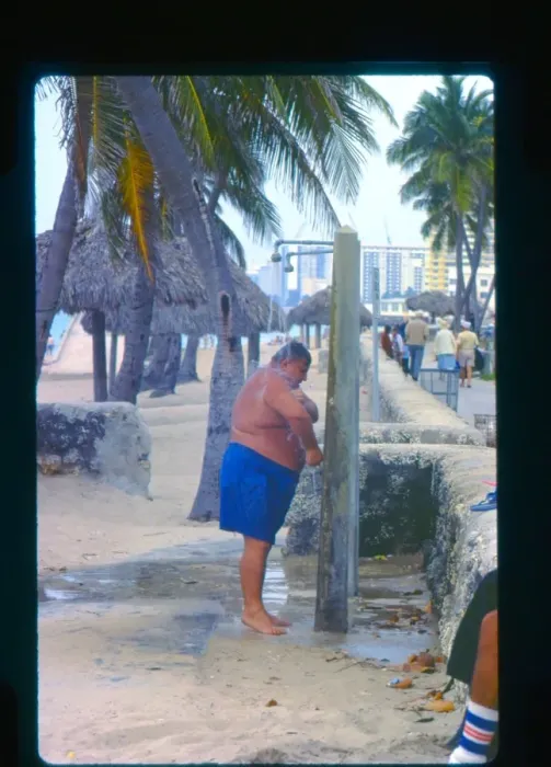 Framed Print : Large man taking a shower, Florida, USA Framed Print : Large man taking a shower, Florida, USA