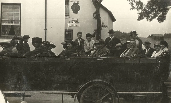 A large open-top Charabanc Party outside a Hotel, about to set off on a tour