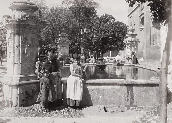 Late 19th century photograph: People with water jars, Public well, fountain, Cordoba
