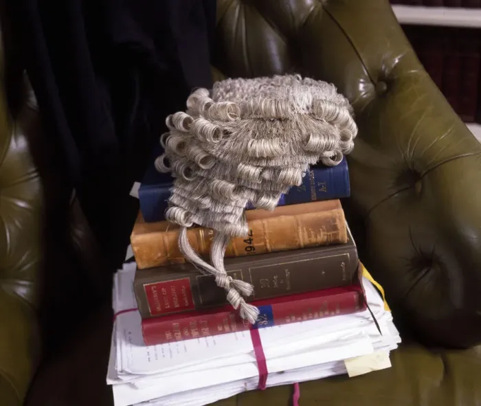 Framed Print : Lawyers books, brief and wig in a leather chair Framed Print : Lawyers books, brief and wig in a leather chair