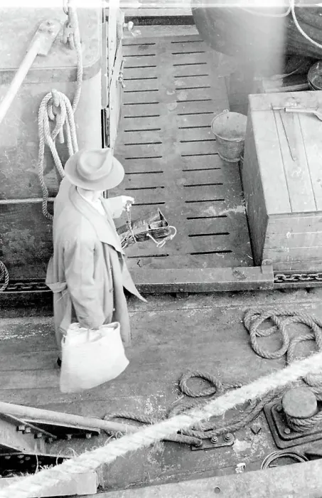 Framed Print : Life on a North Sea trawler - aerial view onto the deck - man in raincoat and trilby hat, carrying a shopping bag. Date: 1960s Framed Print : Life on a North Sea trawler - aerial view onto the deck - man in raincoat and trilby hat, carrying a shopping bag. Date: 1960s