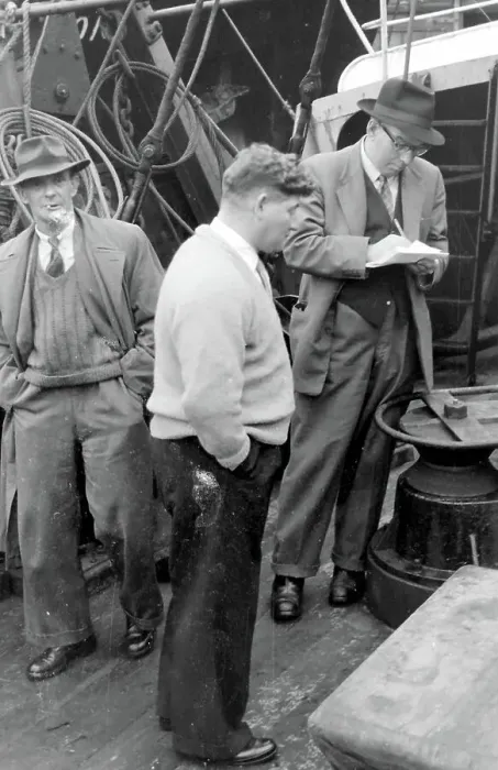 Framed Print : Life on a North Sea trawler - three men on deck in ordinary clothes, one of them writing on a piece of paper. Date: 1960s Framed Print : Life on a North Sea trawler - three men on deck in ordinary clothes, one of them writing on a piece of paper. Date: 1960s