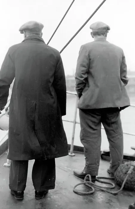 Framed Print : Life on a North Sea trawler - two men on deck in raincoat, jacket, and flat caps, close to shore. Date: 1960s Framed Print : Life on a North Sea trawler - two men on deck in raincoat, jacket, and flat caps, close to shore. Date: 1960s