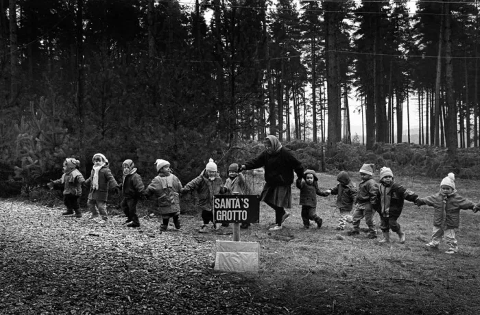 Framed Print : A line of small children are led to Santas grotto Framed Print : A line of small children are led to Santas grotto