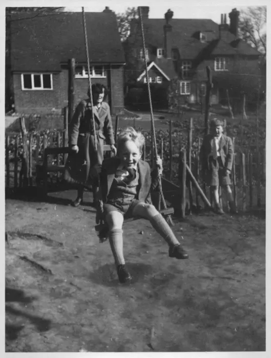 Framed Print : A little boy beaming widely as he gets a push on a garden swing Framed Print : A little boy beaming widely as he gets a push on a garden swing