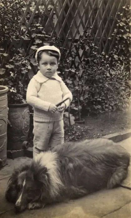 Framed Print : Little boy with large dog in a garden Framed Print : Little boy with large dog in a garden