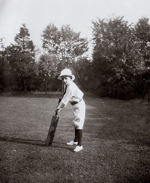 Little boy practising cricket in garden, Ealing, West London