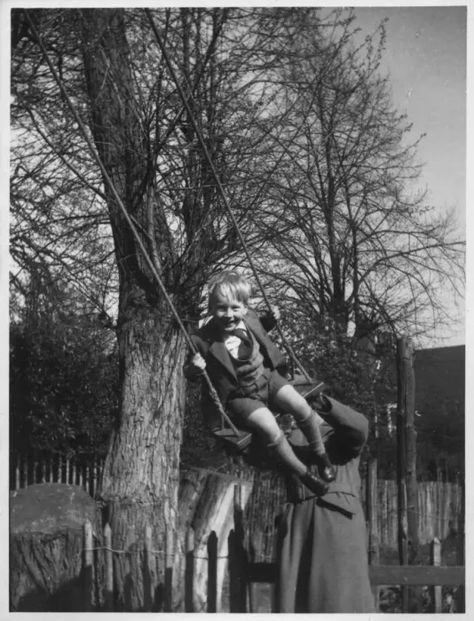 Framed Print : A little boy being pushed on a swing. Date: c. 1950 Framed Print : A little boy being pushed on a swing. Date: c. 1950