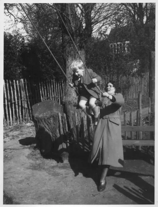 Framed Print : A little boy being pushed on a swing. Date: c. 1950 Framed Print : A little boy being pushed on a swing. Date: c. 1950