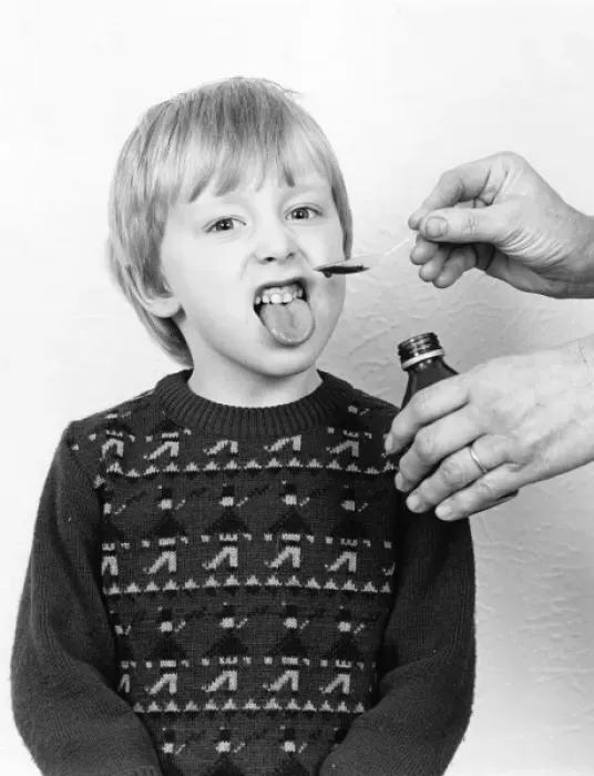 Framed Print : Little boy reluctantly taking his medicine Framed Print : Little boy reluctantly taking his medicine