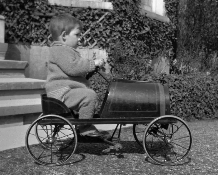 Framed Print : Little boy riding in a toy car Framed Print : Little boy riding in a toy car
