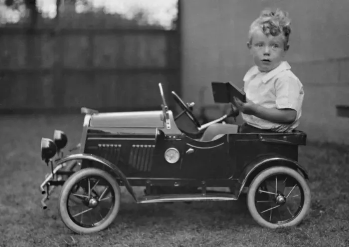Framed Print : Little boy sitting in a toy car Framed Print : Little boy sitting in a toy car