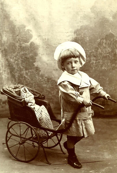Little boy with a toy rickshaw