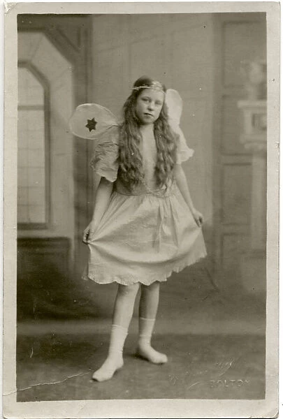 A little girl called Maggie in fancy dress, wearing a fairy costume on Pancake Tuesday
