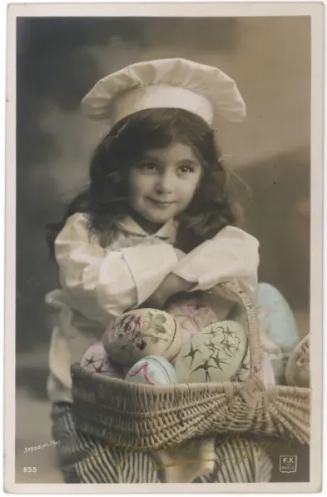 Framed Print : Little girl in chefs costume with a basket of painted eggs Framed Print : Little girl in chefs costume with a basket of painted eggs
