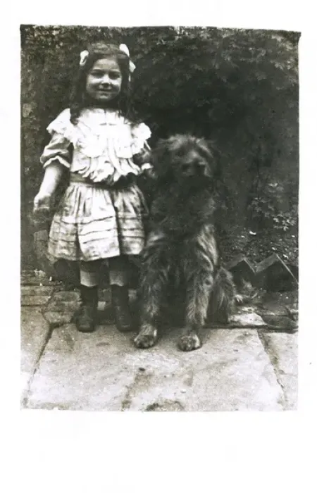 Framed Print : Little girl with a dog in a garden Framed Print : Little girl with a dog in a garden