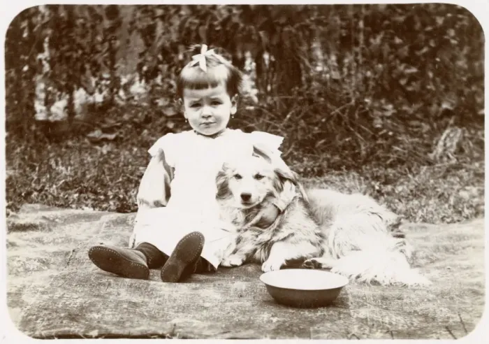 Framed Print : Little girl with a dog in a garden, Normandy, France Framed Print : Little girl with a dog in a garden, Normandy, France