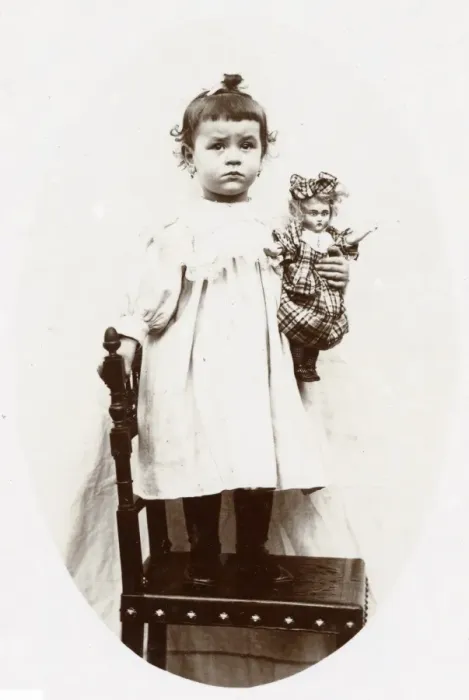 Framed Print : Little girl with doll, Normandy, France Framed Print : Little girl with doll, Normandy, France