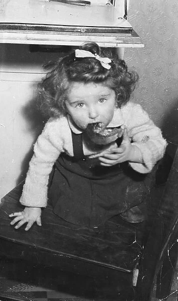 Little girl eating a crust