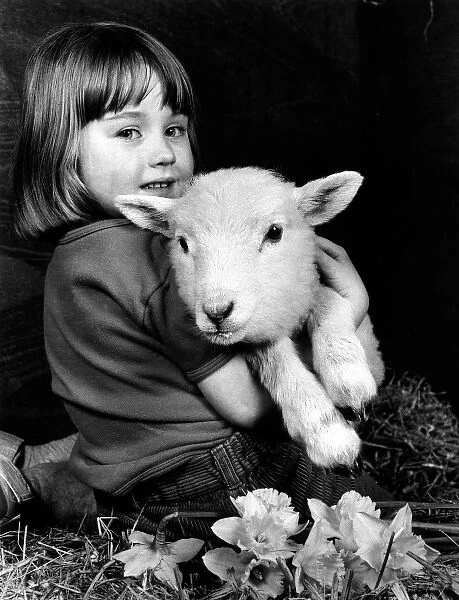 Little girl holding a lamb