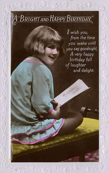 Little girl holds a birthday card
