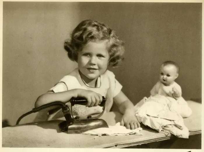 Framed Print : Little girl ironing her dolls clothes Framed Print : Little girl ironing her dolls clothes