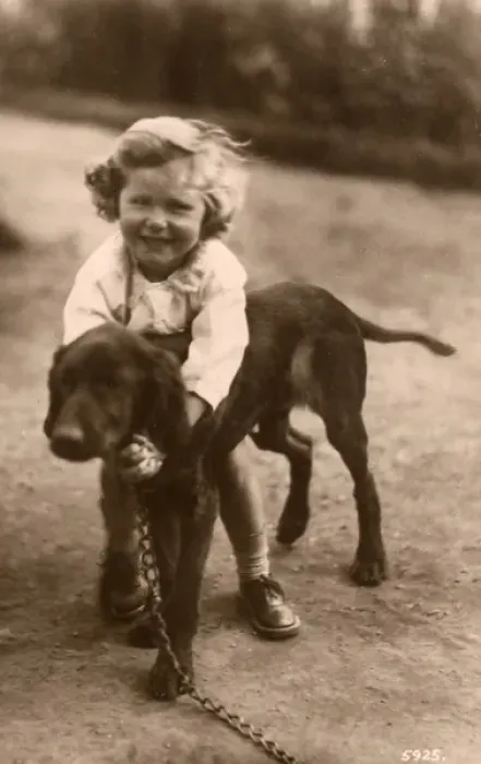 Framed Print : Little girl with a large puppy in a garden Framed Print : Little girl with a large puppy in a garden