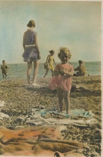 A little girl pictured playing on the beach at Bognor Regis, 1920s. Date: 1920s