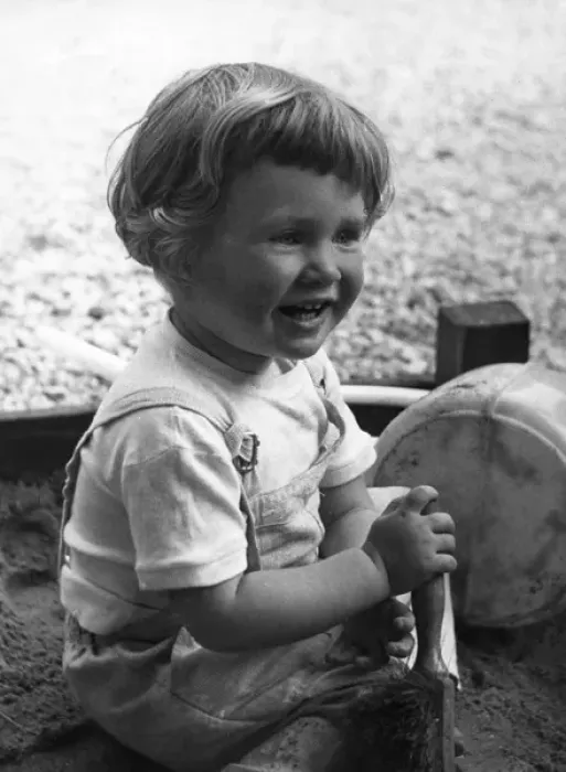 Framed Print : Little girl playing in sandpit