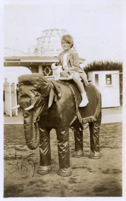 Framed Print : Little girl and her toy dog ride a model Elephant - Margate Framed Print : Little girl and her toy dog ride a model Elephant - Margate