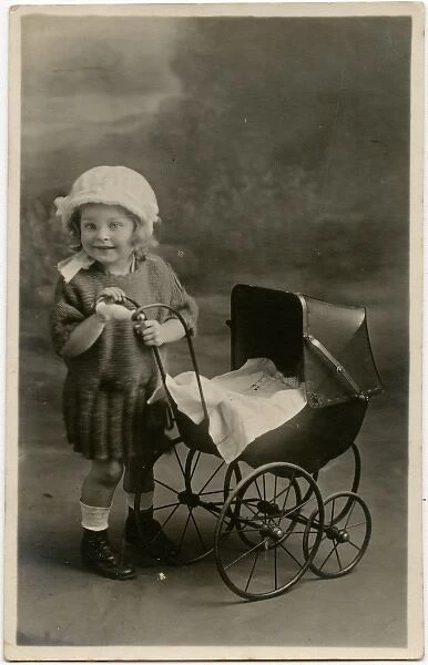 Little girl with toy pram