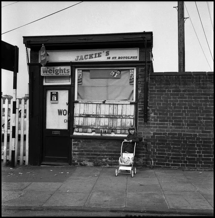 Framed Print : Little girl withy pushchair outside shop Framed Print : Little girl withy pushchair outside shop