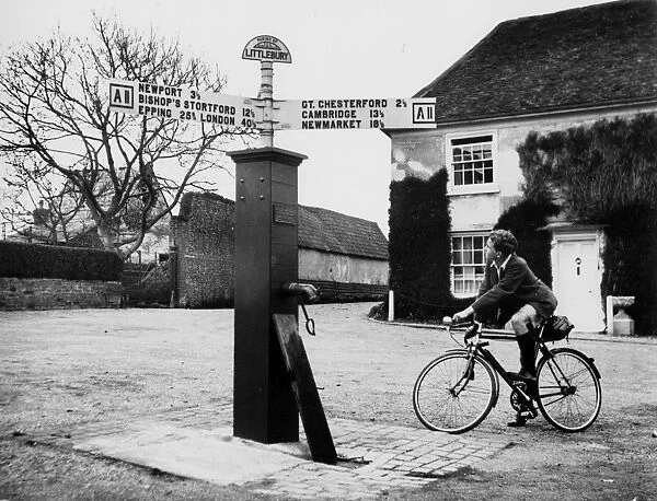 Littlebury Cylist. The old-time centre of village life is the Village Pump at Littlebury