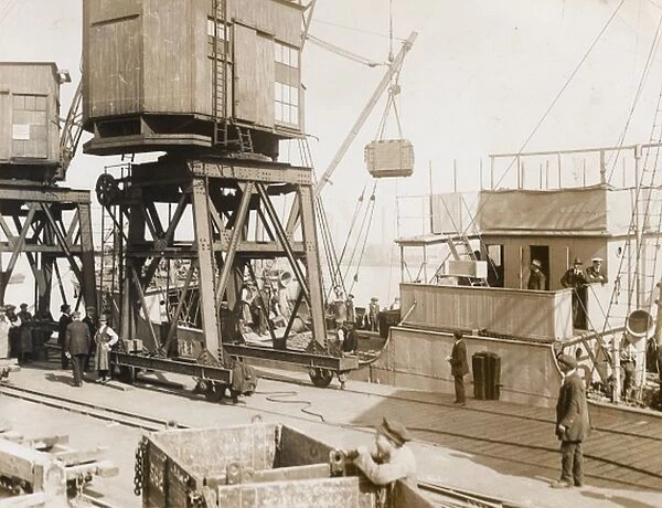 Loading up a boat at a supply depot in UK, WW1