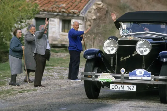 Framed Print : Local people wave to driver of a vintage Hispano Suiza car