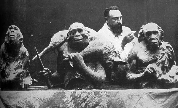 Louis Mascre with sculptures of evolutionary man