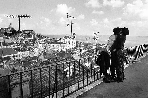 Lovers in Lisbon. Young lovers kiss on the Miradouro de Santa Luzia overlooking